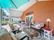 Covered lanai with comfortable seating and decorative outdoor rug at 1626 Brooksbend Dr, Wesley Chapel, FL 33543