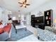 Open concept living room with tile floors, ceiling fan, and view into kitchen with breakfast bar seating at 1626 Brooksbend Dr, Wesley Chapel, FL 33543