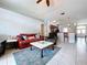 Bright living room with tile floors, ceiling fan, and view to the entryway and breakfast bar at 1626 Brooksbend Dr, Wesley Chapel, FL 33543