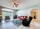 Cozy living room with tile floors, ceiling fan, and patio access at 1626 Brooksbend Dr, Wesley Chapel, FL 33543