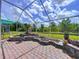 Screened-in patio with brick floor and landscaped planters at 1626 Brooksbend Dr, Wesley Chapel, FL 33543
