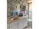 Bathroom with floral wallpaper, large mirror, and neutral vanity at 1679 S Lake Ave # 4, Clearwater, FL 33756