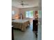 Inviting bedroom with vintage lamps, shuttered windows, and a patterned bedspread at 1679 S Lake Ave # 4, Clearwater, FL 33756