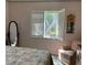 Serene bedroom featuring shuttered windows, soft lighting, and comfortable seating at 1679 S Lake Ave # 4, Clearwater, FL 33756