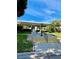 Inviting community entrance featuring palm trees, greenery, and ample parking at 1679 S Lake Ave # 4, Clearwater, FL 33756