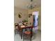 Cozy dining area with chandelier, table setting, and pass-through to kitchen at 1679 S Lake Ave # 4, Clearwater, FL 33756