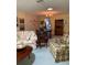 Inviting living area with a floral sofa, patterned armchair, and ample natural light at 1679 S Lake Ave # 4, Clearwater, FL 33756