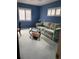 Cozy blue living room with shuttered windows, floral sofa, and oval glass coffee table at 1679 S Lake Ave # 4, Clearwater, FL 33756