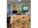 Bright living room featuring an open layout and comfortable floral sofa with view to adjacent area at 1679 S Lake Ave # 4, Clearwater, FL 33756