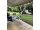Covered patio with outdoor seating and views of the lush, green backyard at 1679 S Lake Ave # 4, Clearwater, FL 33756