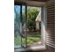 Sunlit room view overlooking backyard foliage and a hanging wind chime at 1679 S Lake Ave # 4, Clearwater, FL 33756