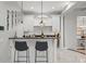 Entertain guests at this bar featuring custom cabinetry, granite countertop, and elegant marble flooring at 17062 Comunidad De Avila, Lutz, FL 33548
