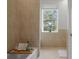 Bright bathroom features a tub with a tray, a window view and neutral tile at 17062 Comunidad De Avila, Lutz, FL 33548