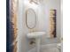 Bathroom with stand-up sink, an oval mirror, and modern lighting at 17062 Comunidad De Avila, Lutz, FL 33548