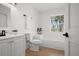 Clean and bright bathroom with a tub, toilet, vanity, and a window view at 17062 Comunidad De Avila, Lutz, FL 33548