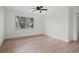 Minimalist bedroom featuring light wood floors and a large bright window at 17062 Comunidad De Avila, Lutz, FL 33548