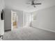 Bright bedroom has neutral paint and trim, grey carpet and a ceiling fan at 17062 Comunidad De Avila, Lutz, FL 33548