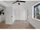 Bright bedroom featuring a ceiling fan, wood flooring, and closet space at 17062 Comunidad De Avila, Lutz, FL 33548