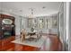Formal dining room with hardwood floors, decorative fireplace, large windows, and a dining table set for ten at 17062 Comunidad De Avila, Lutz, FL 33548
