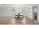 Bright dining room with modern chandelier, large windows, and a round table with seating for four at 17062 Comunidad De Avila, Lutz, FL 33548