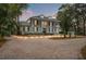 Stunning two-story home featuring a brick driveway, large columns, second floor balcony and a well-manicured front yard at 17062 Comunidad De Avila, Lutz, FL 33548