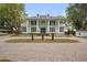 Beautiful stately home featuring symmetrical columns, upper balconies,dormers, and a circular brick driveway, creating a grand curb appeal at 17062 Comunidad De Avila, Lutz, FL 33548