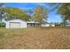 Wide view of property with garage and ample lawn space with mature trees at 17062 Comunidad De Avila, Lutz, FL 33548