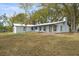 Charming exterior view of home with long front porch and ample lawn space at 17062 Comunidad De Avila, Lutz, FL 33548