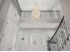 Grand foyer featuring a stunning chandelier, white double doors with decorative glass, and elegant wrought iron staircase railings at 17062 Comunidad De Avila, Lutz, FL 33548