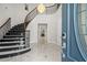 Grand foyer featuring a curved staircase with decorative wrought iron railing, elegant chandelier and marble floors at 17062 Comunidad De Avila, Lutz, FL 33548