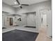 Spacious home gym featuring mirrored walls, dark flooring and neutral paint at 17062 Comunidad De Avila, Lutz, FL 33548