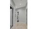 Hallway view with marble flooring, multiple doors, and neutral paint at 17062 Comunidad De Avila, Lutz, FL 33548