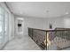 Hallway with marble floors, chandelier, and decorative railing leading to second floor at 17062 Comunidad De Avila, Lutz, FL 33548