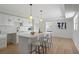Open kitchen with counter seating and adjacent rooms and modern fixtures and plenty of natural light at 17062 Comunidad De Avila, Lutz, FL 33548