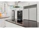 Close up shot of a kitchen with white cabinets, black appliances, and granite countertops at 17062 Comunidad De Avila, Lutz, FL 33548