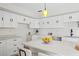 Bright kitchen featuring white cabinets, quartz countertops, modern fixtures, and ample counter space at 17062 Comunidad De Avila, Lutz, FL 33548