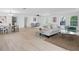 Spacious open living area with modern decor, dining area, light wood flooring, and ample natural light at 17062 Comunidad De Avila, Lutz, FL 33548