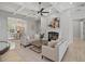 Cozy living room with coffered ceilings, fireplace, neutral furnishings, and seamless access to the dining area at 17062 Comunidad De Avila, Lutz, FL 33548