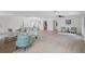 Bright, open-concept living room with modern furnishings and neutral decor and light wood flooring at 17062 Comunidad De Avila, Lutz, FL 33548