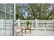 Relaxing patio with chair and table, framed by elegant white balusters at 17062 Comunidad De Avila, Lutz, FL 33548