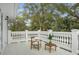 Open-air patio with white balusters and seating, nestled in nature at 17062 Comunidad De Avila, Lutz, FL 33548