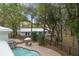 Aerial view showcasing a backyard pool and patio area surrounded by trees at 17062 Comunidad De Avila, Lutz, FL 33548
