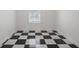Unfurnished room with decorative black and white tile floors and a window view at 17062 Comunidad De Avila, Lutz, FL 33548