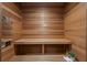 Modern sauna room with wood walls, bench seating, and equipment at 17062 Comunidad De Avila, Lutz, FL 33548
