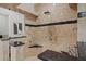 Close up of the travertine shower, equipped with multiple shower heads and black trim at 17062 Comunidad De Avila, Lutz, FL 33548