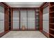 Walk-in closet with beautiful mahogany shelves and rods for a well-organized storage space at 17062 Comunidad De Avila, Lutz, FL 33548