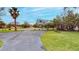 Long driveway lined by mature landscaping and palm trees, leading to the property at 175 Bath Club N Blvd, North Redington Beach, FL 33708