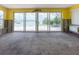 Bright, spacious room with large sliding doors offering serene waterfront views at 175 Bath Club N Blvd, North Redington Beach, FL 33708