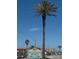 Welcome to Redington Shores, a beautiful coastal town, featuring palm trees, buildings, and a clear blue sky at 175 Bath Club N Blvd, North Redington Beach, FL 33708