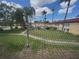 View of community pool, green space, and condos through a screened window at 1845 S Highland Ave # 6-11, Largo, FL 33756